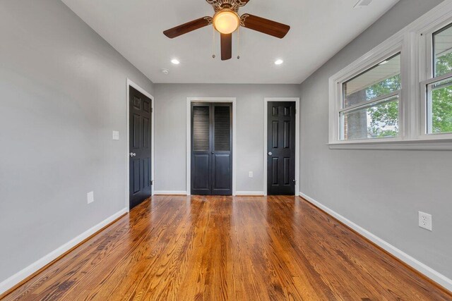 unfurnished bedroom with baseboards, recessed lighting, and wood finished floors
