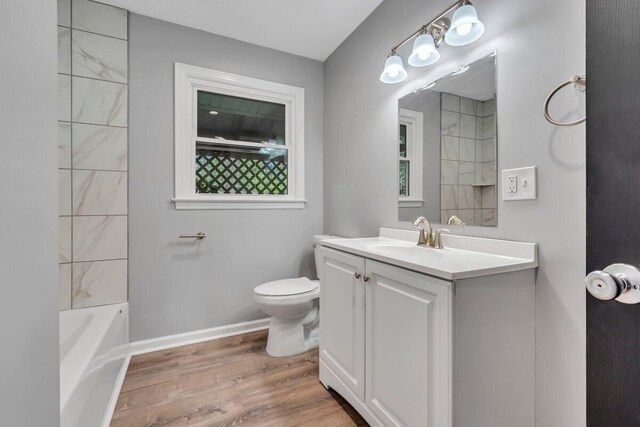 full bathroom featuring vanity, wood finished floors, and toilet
