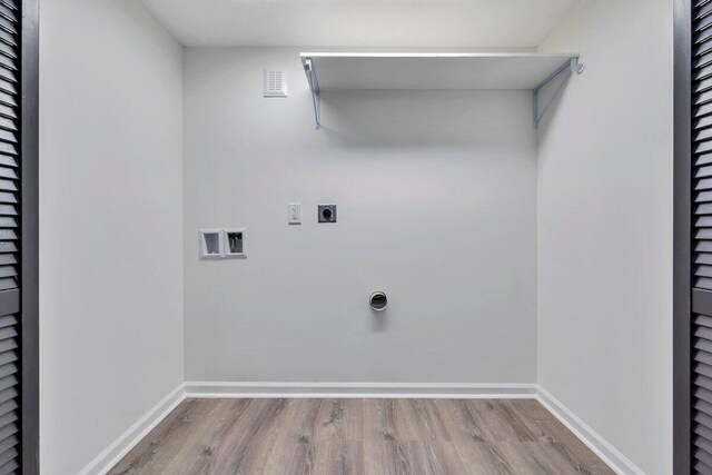 washroom with washer hookup, electric dryer hookup, wood finished floors, and laundry area