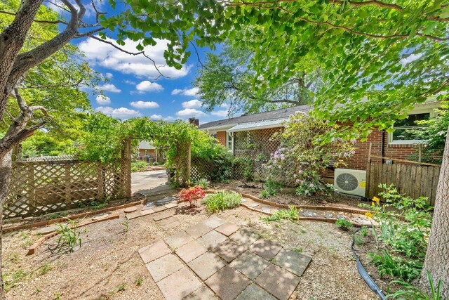 view of yard with a patio, ac unit, and fence