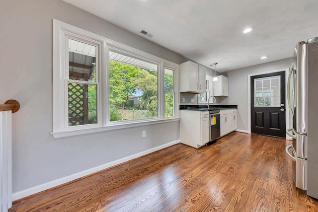 kitchen with baseboards, plenty of natural light, and stainless steel appliances
