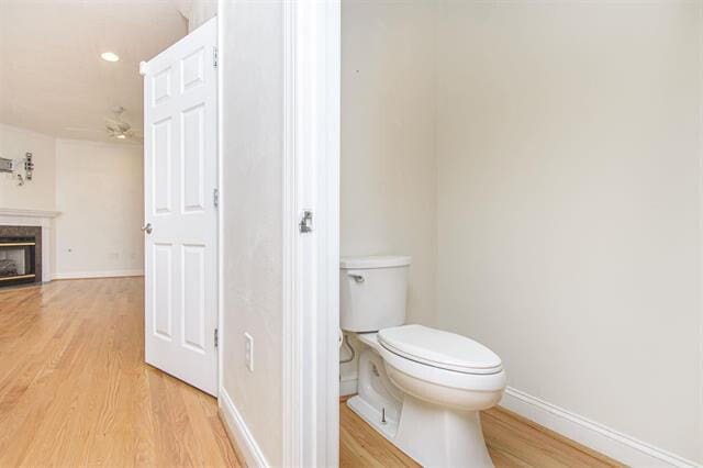 bathroom featuring wood-type flooring and toilet