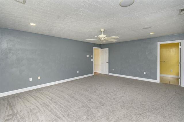 unfurnished bedroom with a textured ceiling, carpet, and ceiling fan