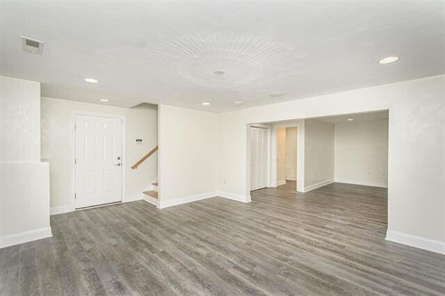 unfurnished room with dark hardwood / wood-style floors