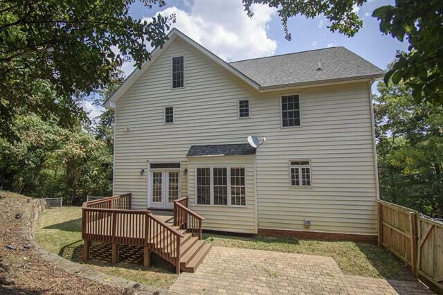 rear view of house featuring a wooden deck