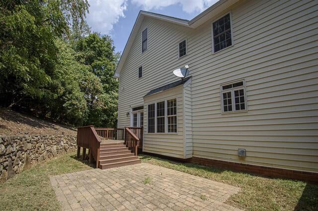 rear view of house featuring a patio area and a deck