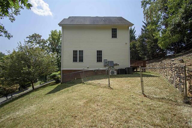 back of house with a lawn