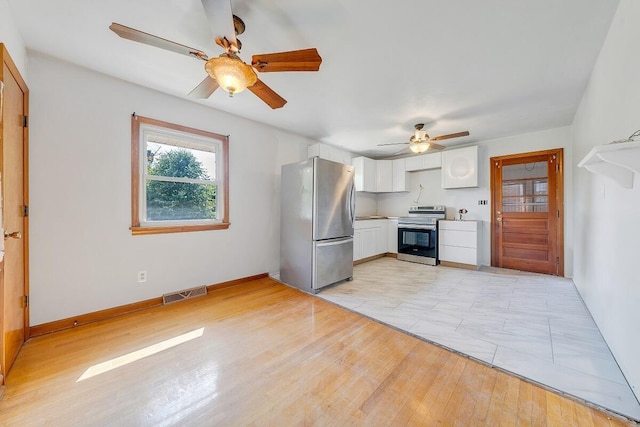 2422 Kingston Rd NW, Roanoke, VA 24017 - kitchen featuring stainless steel appliances, ceiling fan, white cabinets, light wood-type flooring, and light countertops