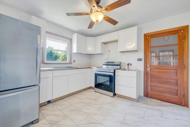 2422 Kingston Rd NW, Roanoke, VA 24017 - kitchen featuring appliances with stainless steel finishes, white cabinets, light countertops, and light marble finish floors