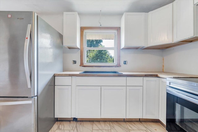 2422 Kingston Rd NW, Roanoke, VA 24017 - kitchen featuring stainless steel appliances, white cabinets, and light countertops