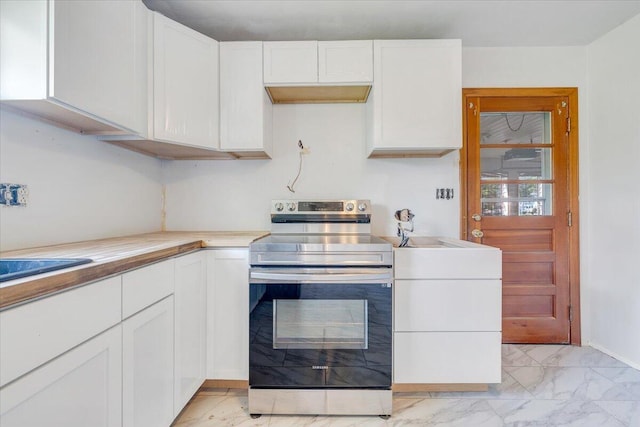 2422 Kingston Rd NW, Roanoke, VA 24017 - kitchen with electric stove, light marble finish flooring, and white cabinets