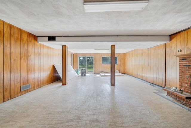 2422 Kingston Rd NW, Roanoke, VA 24017 - unfurnished room with wooden walls, beamed ceiling, and a textured ceiling