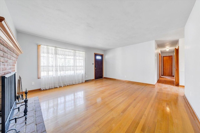 2422 Kingston Rd NW, Roanoke, VA 24017 - unfurnished living room with light wood-style floors and a fireplace