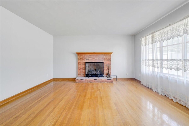2422 Kingston Rd NW, Roanoke, VA 24017 - unfurnished living room featuring light wood-style floors and a brick fireplace