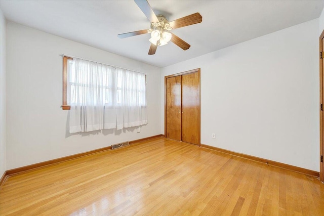 2422 Kingston Rd NW, Roanoke, VA 24017 - unfurnished bedroom featuring a closet, light wood-style flooring, and a ceiling fan