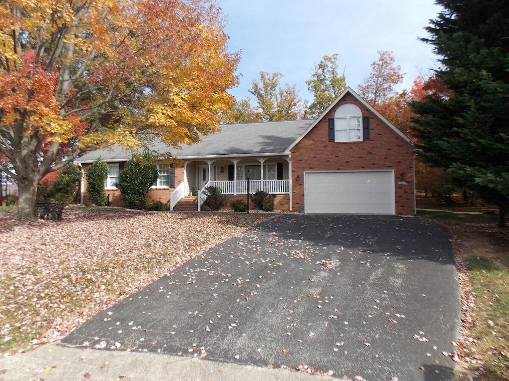 view of front of home with covered porch and a garage