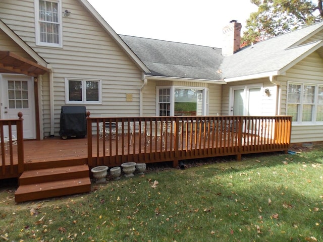 wooden terrace with a lawn