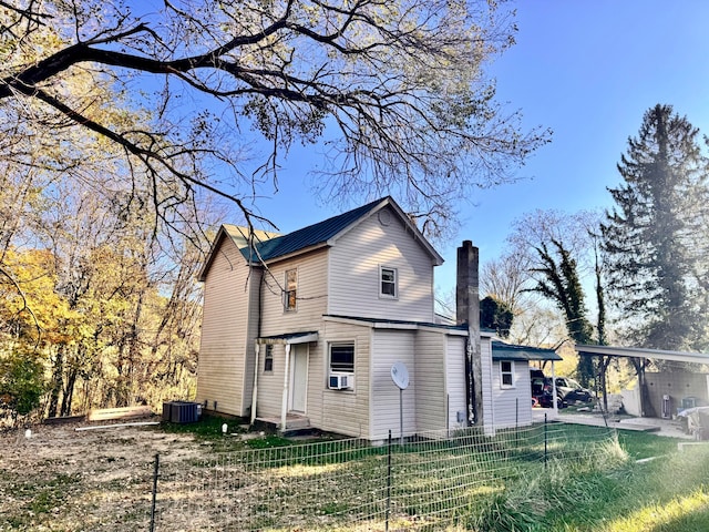 back of property with central AC unit and cooling unit