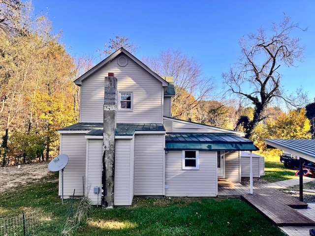 back of house featuring a deck and a yard