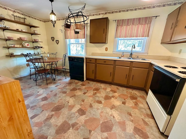 kitchen with pendant lighting, white range with electric cooktop, plenty of natural light, and sink