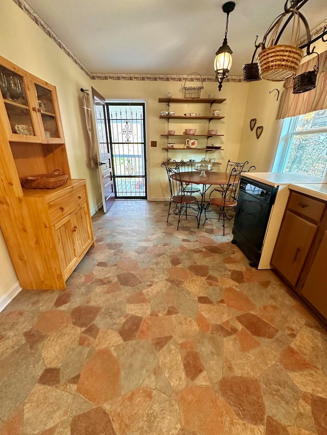 kitchen featuring a wealth of natural light, dishwasher, and pendant lighting