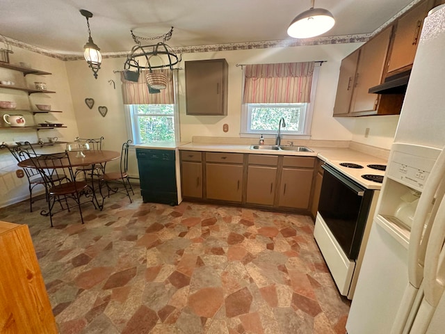 kitchen with white appliances, sink, and hanging light fixtures