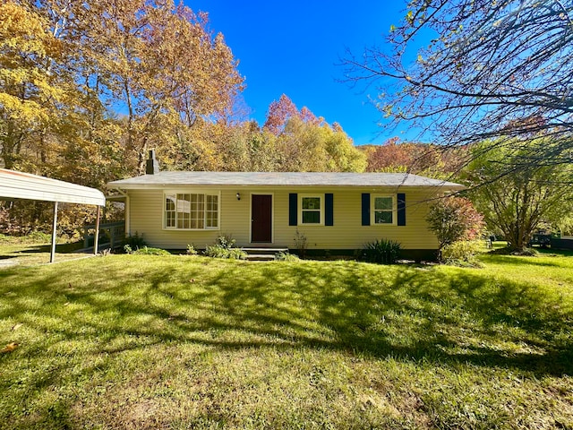 ranch-style home with a front yard and a carport