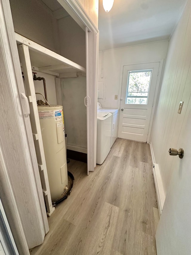 laundry room featuring light hardwood / wood-style floors, washer and clothes dryer, and water heater