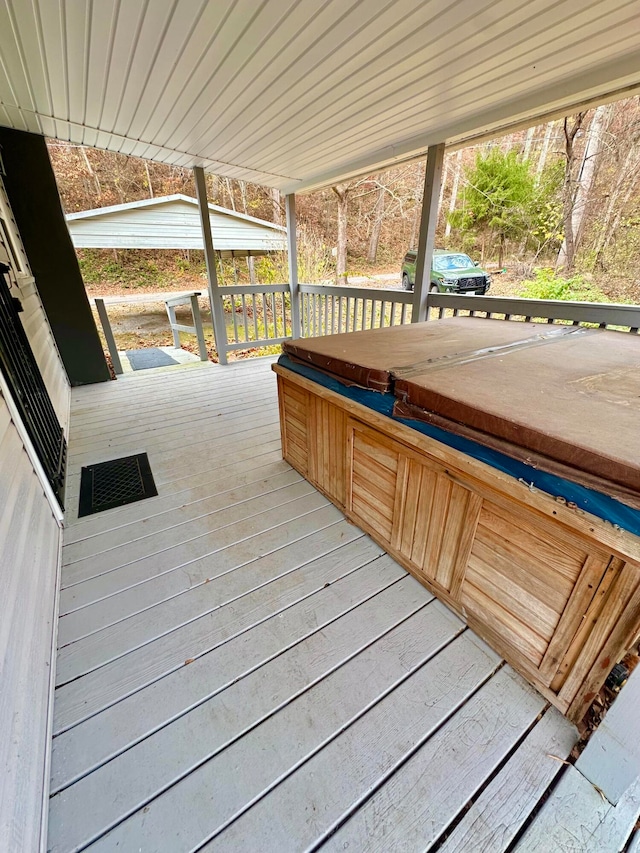 deck with a covered hot tub