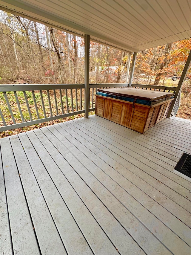 wooden terrace with a covered hot tub