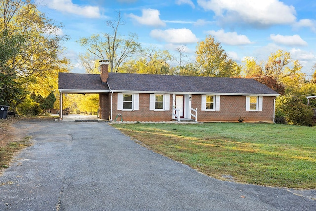 ranch-style home with a front lawn and a carport