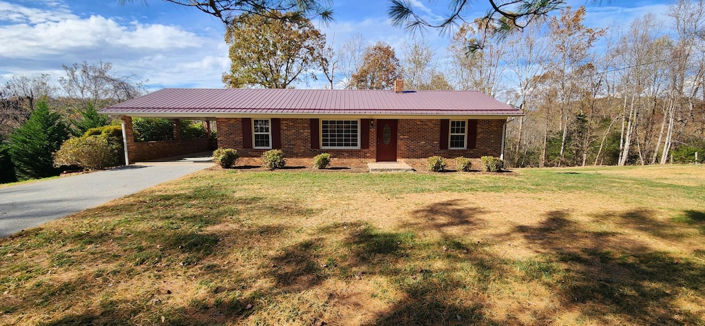 single story home with a front lawn and a carport