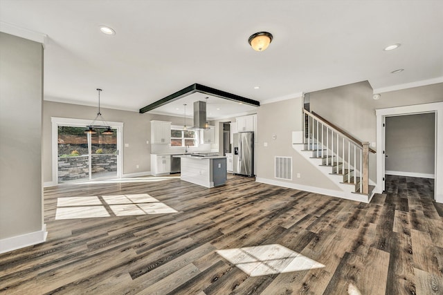 unfurnished living room with dark hardwood / wood-style floors and crown molding