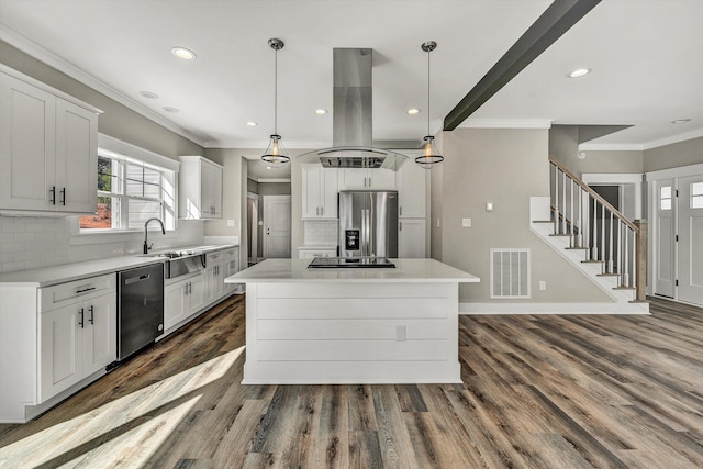 kitchen featuring white cabinetry, appliances with stainless steel finishes, island range hood, decorative light fixtures, and a kitchen island