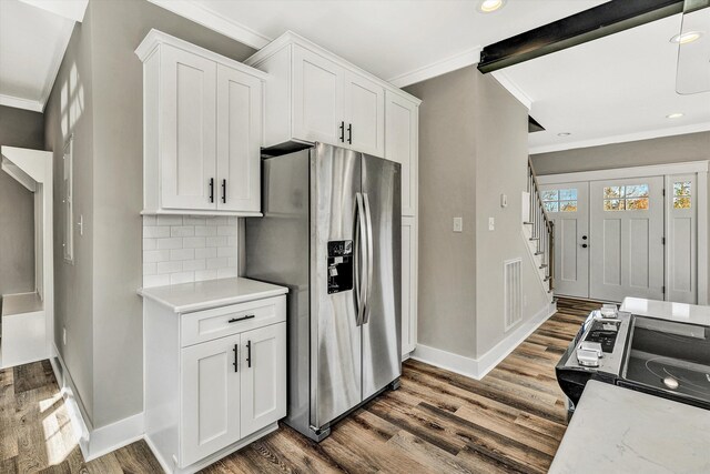 1154 Barrow Hills Dr, Huddleston, VA 24104 - kitchen featuring stainless steel refrigerator with ice dispenser, ornamental molding, baseboards, wood finished floors, and white cabinets