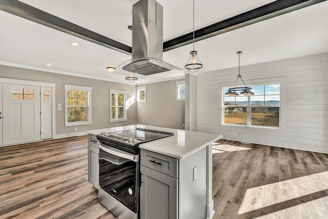 kitchen with plenty of natural light, a kitchen island, hanging light fixtures, and stainless steel electric stove