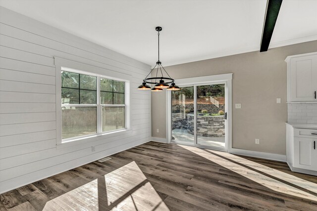 1154 Barrow Hills Dr, Huddleston, VA 24104 - unfurnished dining area with healthy amount of natural light, a chandelier, dark wood-style floors, wooden walls, and crown molding