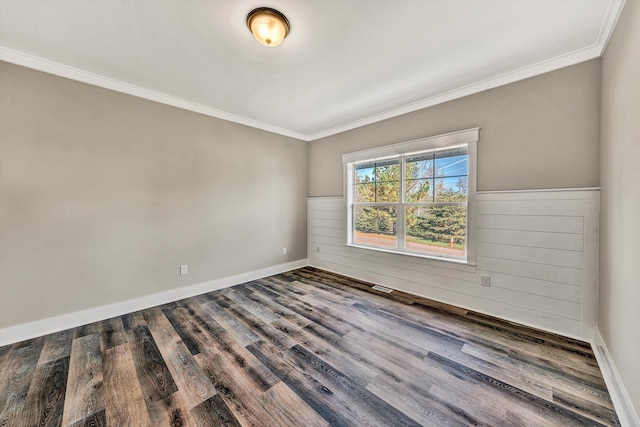 spare room featuring ornamental molding and hardwood / wood-style flooring