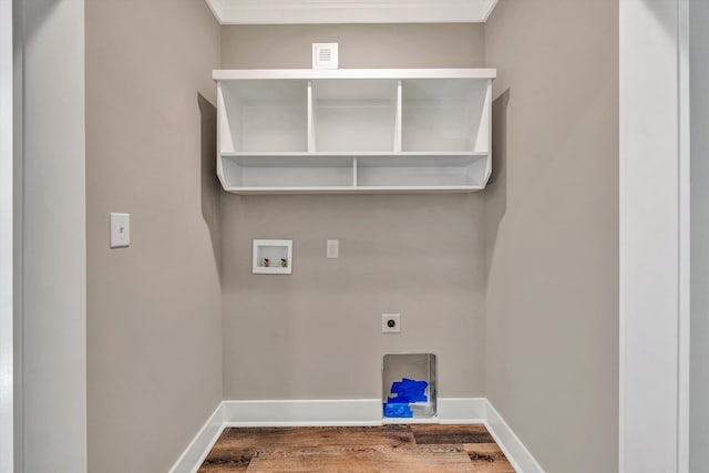 washroom featuring washer hookup, hardwood / wood-style flooring, ornamental molding, and hookup for an electric dryer