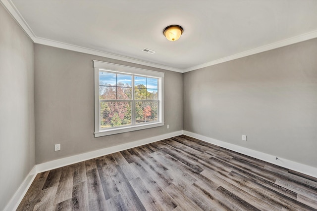 spare room with hardwood / wood-style flooring and ornamental molding