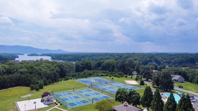 aerial view featuring a wooded view and a mountain view