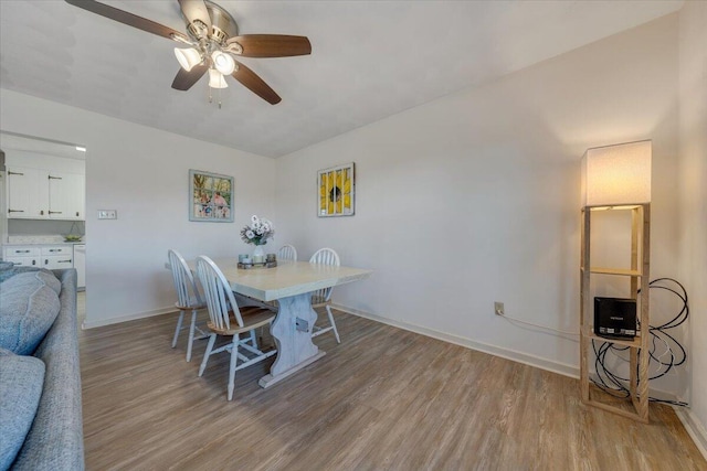 dining room featuring light wood-type flooring and ceiling fan