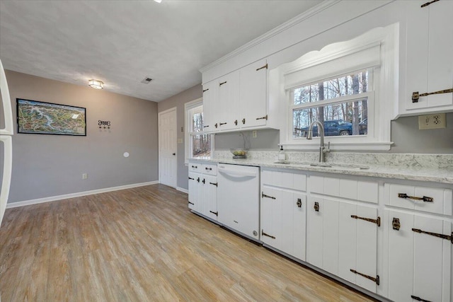 kitchen featuring white cabinets, dishwasher, light wood-type flooring, and sink