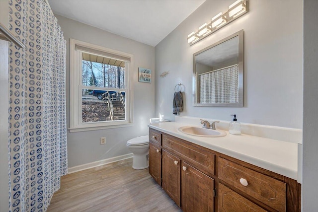 bathroom with vanity, hardwood / wood-style flooring, and toilet