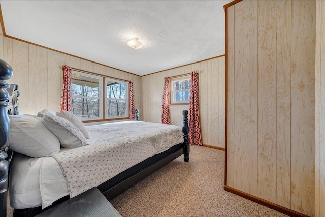 carpeted bedroom featuring wooden walls