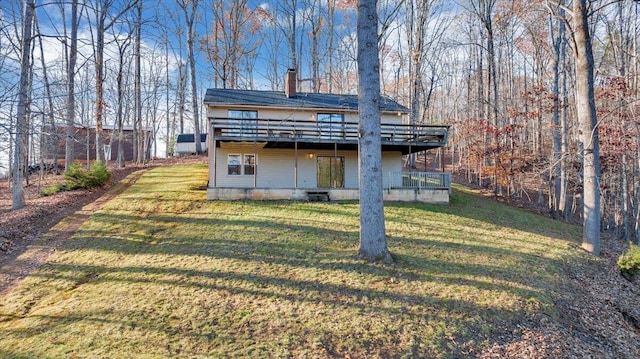 back of house with a lawn and a deck