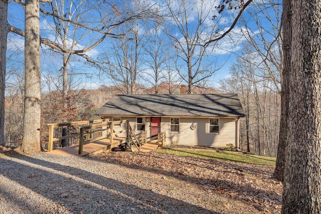 ranch-style home with a wooden deck