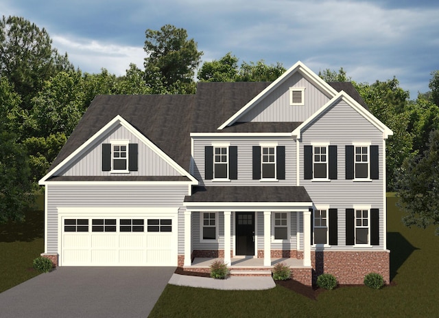 view of front of home with a garage and a front lawn