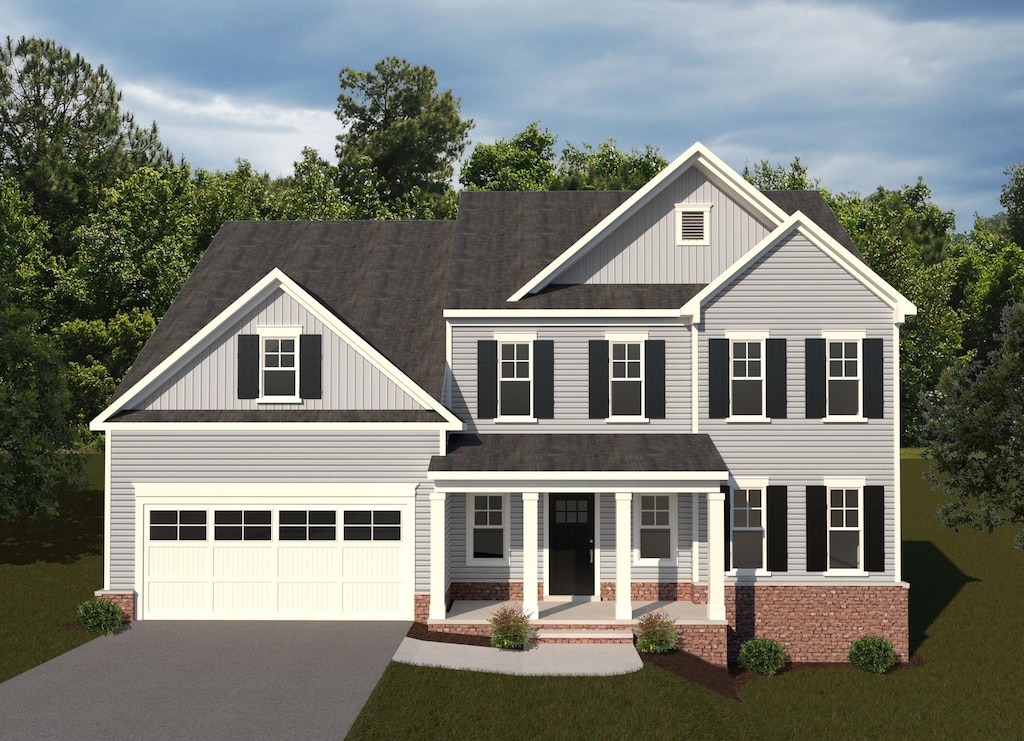 view of front of property featuring a garage and a front yard