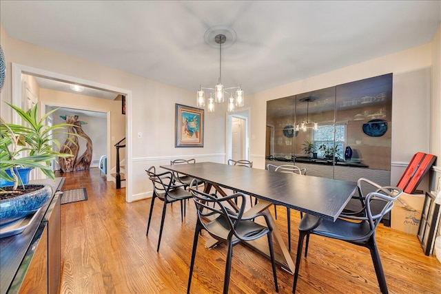 dining room featuring an inviting chandelier and light wood-type flooring